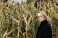 Stylish woman in black coat and glasses in autumn corn field Stylish woman in black coat and glasses in autumn corn field - PhotoDune Item for Sale
