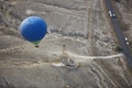 Blur hot air balloon flying over the road with motor transport. View from above Blur hot air balloon flying over the road with motor transport. View from above - PhotoDune Item for Sale