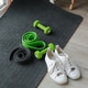 white sports shoes, dumbbells, fitness rubber bands, on a black sports mat white sports shoes, dumbbells, fitness rubber bands, on a black sports mat - PhotoDune Item for Sale
