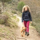 Curly and blonde hair, mountaineer woman and her dog walking through the mountains. Curly and blonde hair, mountaineer woman and her dog walking through the mountains. - PhotoDune Item for Sale