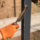 Person cleaning metal surface outdoors with wire brush and orange glove Person cleaning metal surface outdoors with wire brush and orange glove - PhotoDune Item for Sale