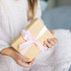Young girl in pink dress holding a wrapped gift with pink ribbon Young girl in pink dress holding a wrapped gift with pink ribbon - PhotoDune Item for Sale