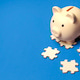 Pink Piggy Bank on Top of Jigsaw Puzzle Pieces for Financial Solutions Pink Piggy Bank on Top of Jigsaw Puzzle Pieces for Financial Solutions - PhotoDune Item for Sale