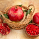 Front view (pomegranate) a pomegranate was put into the basket next to a chopped whole with a bowl Front view (pomegranate) a pomegranate was put into the basket next to a chopped whole with a bowl - PhotoDune Item for Sale