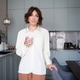 woman with glass of water in hands in kitchen at home. woman with glass of water in hands in kitchen at home. - PhotoDune Item for Sale