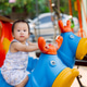 Close-up portrait of a curious toddler sitting on a blue spring rider at a playground. Close-up portrait of a curious toddler sitting on a blue spring rider at a playground. - PhotoDune Item for Sale