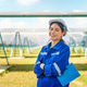 Smiling woman standing near solar panels at renewable energy site during daytime Smiling woman standing near solar panels at renewable energy site during daytime - PhotoDune Item for Sale