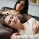 Young woman touching lesbian partner in sweater on couch Young woman touching lesbian partner in sweater on couch - PhotoDune Item for Sale