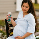 Pregnant woman drinking water from reusable glass bottle outdoor.Hydration during pregnancy concept Pregnant woman drinking water from reusable glass bottle outdoor.Hydration during pregnancy concept - PhotoDune Item for Sale