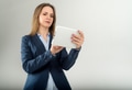 Young business lady uses tablet isolated on grey background Young business lady uses tablet isolated on grey background - PhotoDune Item for Sale