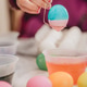 Young millennial Mother at home helping daughter paint colorful Easter eggs for playing and eating Young millennial Mother at home helping daughter paint colorful Easter eggs for playing and eating - PhotoDune Item for Sale