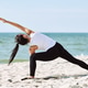 Young woman practicing yoga in extended side angle pose on Baltic Sea sandy beach Young woman practicing yoga in extended side angle pose on Baltic Sea sandy beach - PhotoDune Item for Sale