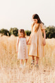 Two little girls wear casual dresses, walking in wheat field. Beautiful countryside. Spring summer Two little girls wear casual dresses, walking in wheat field. Beautiful countryside. Spring summer - PhotoDune Item for Sale