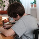 Teenager boy does homework uses smartphone for educational purposes Teenager boy does homework uses smartphone for educational purposes - PhotoDune Item for Sale