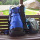 On a sunny summer day, two hiking backpacks on a park bench surrounded by bright flowers On a sunny summer day, two hiking backpacks on a park bench surrounded by bright flowers - PhotoDune Item for Sale