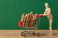 Wooden mannequin with miniature shopping cart Wooden mannequin with miniature shopping cart - PhotoDune Item for Sale