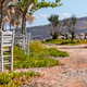 Wooden tables and chairs set outdoors by the sea along a track Wooden tables and chairs set outdoors by the sea along a track - PhotoDune Item for Sale