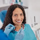 Portrait of smiling dental patient looking at camera at dental clinic Portrait of smiling dental patient looking at camera at dental clinic - PhotoDune Item for Sale