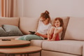 Two little girls children sitting on couch and using laptop tablet pad. Sisters watching cartoons Two little girls children sitting on couch and using laptop tablet pad. Sisters watching cartoons - PhotoDune Item for Sale