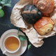 Freshly baked pastries served with a cup of tea, flat lay on dark slate background Freshly baked pastries served with a cup of tea, flat lay on dark slate background - PhotoDune Item for Sale