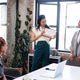 Celebrating achievement, colleagues in modern office, woman holding certificate, smiling Celebrating achievement, colleagues in modern office, woman holding certificate, smiling - PhotoDune Item for Sale