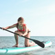 A cute teenage girl in a swim suit paddle boarding in the sea in hot sunny summer day. Vacation. N A cute teenage girl in a swim suit paddle boarding in the sea in hot sunny summer day. Vacation. N - PhotoDune Item for Sale