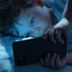 Child Staring at Smartphone in Bed at Night Child Staring at Smartphone in Bed at Night - PhotoDune Item for Sale
