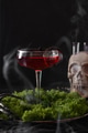 Halloween red cocktail and skull with smoke on black background. Horror funny food. Halloween red cocktail and skull with smoke on black background. Horror funny food. - PhotoDune Item for Sale