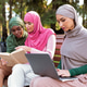 Three Islamic Women Learning Using Computers And Reading Books Outdoor ...