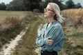 Young stylish woman in blue shirt on countryside road Young stylish woman in blue shirt on countryside road - PhotoDune Item for Sale