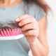 A girl holds dry, fallen hair with a comb after combing. The problem of hair loss and breakage A girl holds dry, fallen hair with a comb after combing. The problem of hair loss and breakage - PhotoDune Item for Sale