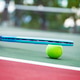 Tennis racket and ball on the court. Tennis racket and ball on the court. - PhotoDune Item for Sale