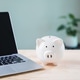 piggy bank e learning education financial money elearning internet sits on wooden desk beside piggy bank e learning education financial money elearning internet sits on wooden desk beside - PhotoDune Item for Sale
