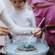 A teenage girl and her sisters spoon blue sugar into a cotton candy machine. A teenage girl and her sisters spoon blue sugar into a cotton candy machine. - PhotoDune Item for Sale