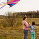 Children girls running flying colorful sky kite. Open field. Spring day. Family nature activity, fun Children girls running flying colorful sky kite. Open field. Spring day. Family nature activity, fun - PhotoDune Item for Sale