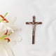A symbolic Christian composition with christian cross lies beside a fresh white lily A symbolic Christian composition with christian cross lies beside a fresh white lily - PhotoDune Item for Sale