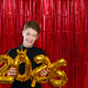 A happy young man holding large gold 2026 number balloons, celebrating the new year . A happy young man holding large gold 2026 number balloons, celebrating the new year . - PhotoDune Item for Sale
