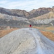 Colorful minimalism hiker on top a hill in Death Valley desert badlands of the 20 mile mile canyon Colorful minimalism hiker on top a hill in Death Valley desert badlands of the 20 mile mile canyon - PhotoDune Item for Sale