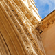 Gothic church portal close-up with richly carved stone arches and statue, upward view. Gothic church portal close-up with richly carved stone arches and statue, upward view. - PhotoDune Item for Sale