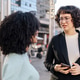 Female friends talking in the street Female friends talking in the street - PhotoDune Item for Sale