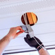 Worker installs lighting fixture in ceiling at residential home during works day Worker installs lighting fixture in ceiling at residential home during works day - PhotoDune Item for Sale