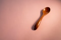 Wooden spoon on pink background Wooden spoon on pink background - PhotoDune Item for Sale