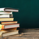 A stack of books on a wooden table A stack of books on a wooden table - PhotoDune Item for Sale