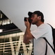 Travel photographer capturing urban architecture with camera in modern city Travel photographer capturing urban architecture with camera in modern city - PhotoDune Item for Sale