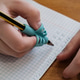 handwriting with a special finger grip trainer. kid's hand holding pencil correctly. calligraphy handwriting with a special finger grip trainer. kid's hand holding pencil correctly. calligraphy - PhotoDune Item for Sale
