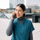 Healthcare professional smiling while using mobile phone Healthcare professional smiling while using mobile phone - PhotoDune Item for Sale