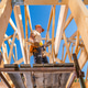 Construction Worker on Scaffolding Under Blue Sky Construction Worker on Scaffolding Under Blue Sky - PhotoDune Item for Sale