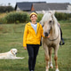 Country Life with Horse and Dog. A full-length portrait of a smiling woman in a yellow jacket Country Life with Horse and Dog. A full-length portrait of a smiling woman in a yellow jacket - PhotoDune Item for Sale