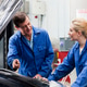 Mechanic discussing car engine with apprentice Stock Photo by Image-Source