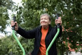 Smiling elderly woman is doing exercises on simulator, trainer ellipse outdoors in the yard Smiling elderly woman is doing exercises on simulator, trainer ellipse outdoors in the yard - PhotoDune Item for Sale